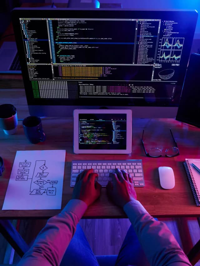 image of a persone working on a laptop with codes on the screen